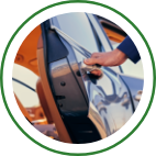 A hand opens the door of a vehicle. 
